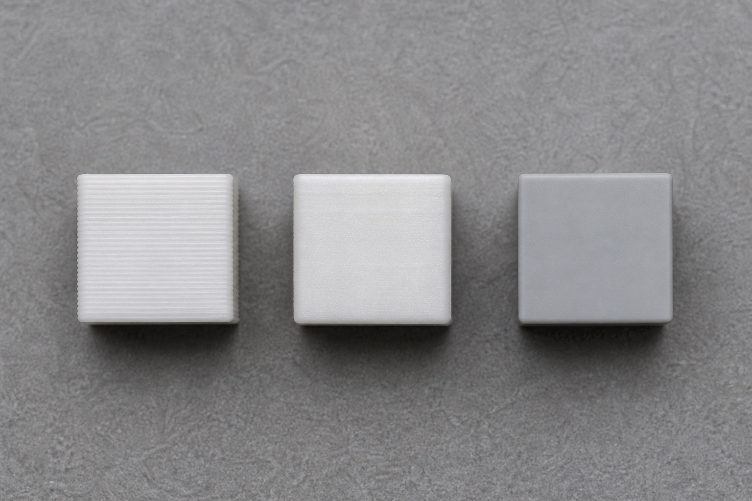 Three test prints showing raw, sanded, and primed surface states